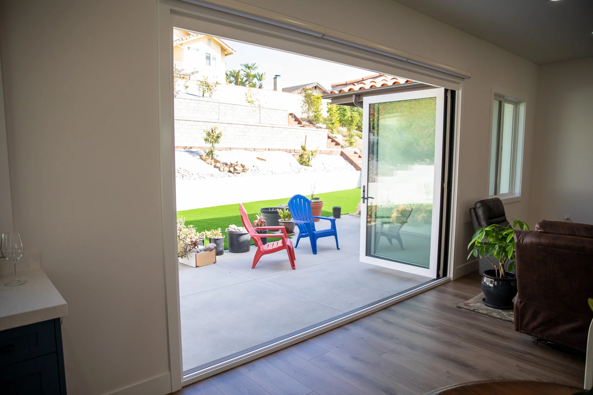 Interior view of room addition with large sliding glass doors opening to patio and backyard