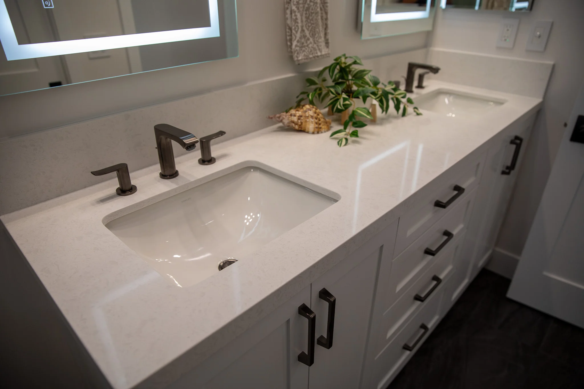 Modern bathroom vanity with white quartz countertop, dual sinks, and matte black fixtures